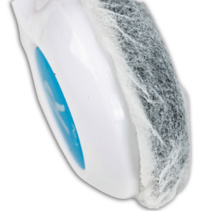 Close-up of a white plastic pod with a blue circle, covered by a white fabric layer showing dark filter material inside, part of K6 / BK Series - Hygienic/Sanitary covers (250 Pairs), ideal for maintaining headphone cleanliness in schools.